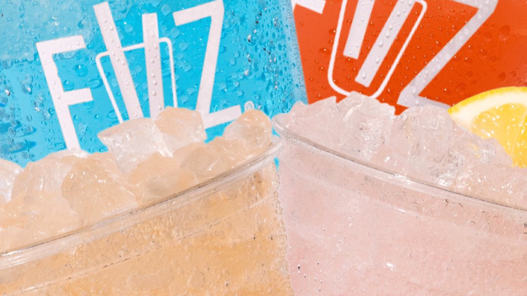 Two iced FiiZ drinks with fresh orange